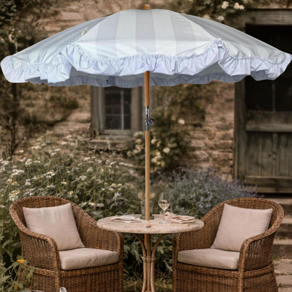 Powder Parlour Celadon Veil vintage-inspired garden parasol set in a cottage garden with table and rattan chairs
