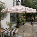 Harbour Bounty wood framed parasol in Oyster Shell colourway, situated on a pavement cafe terrace in London