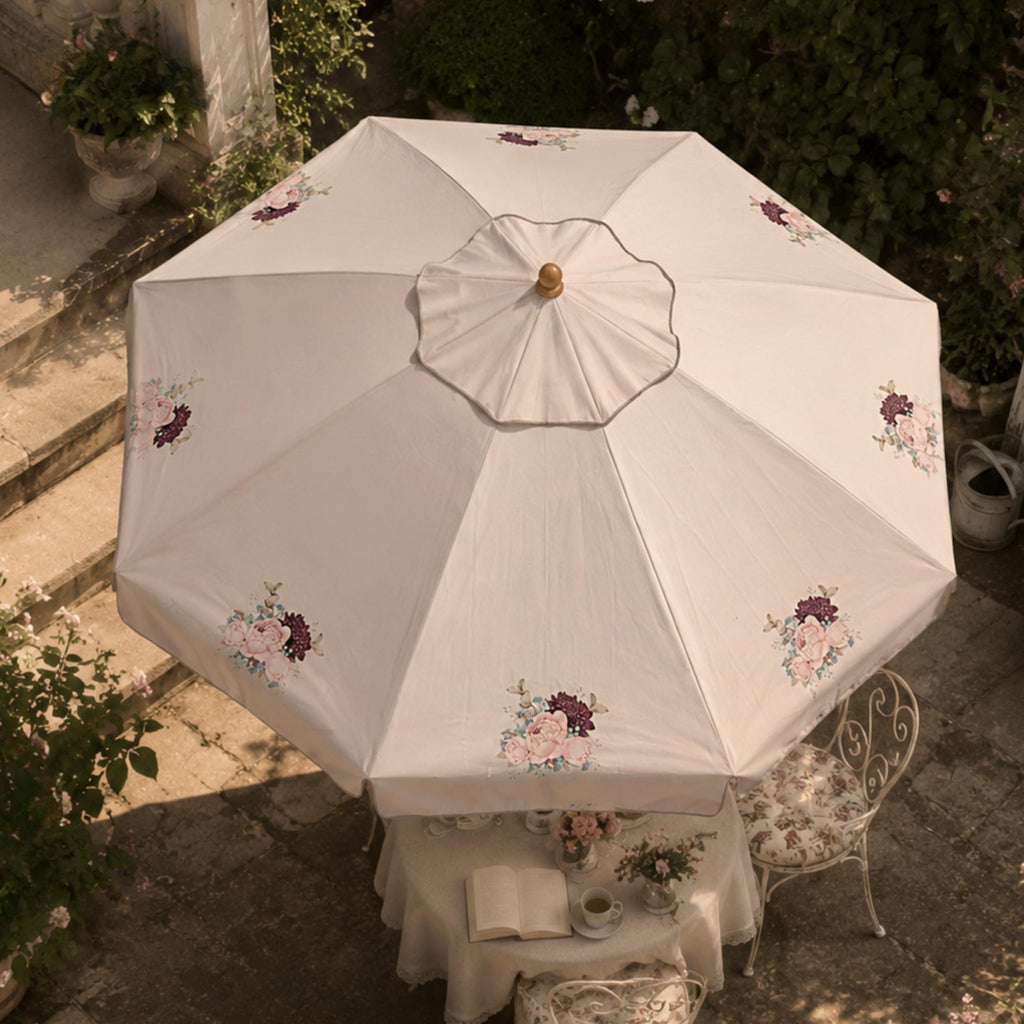 Atelier Belle garden parasol featuring the Helena floral motif and decorative trim.
